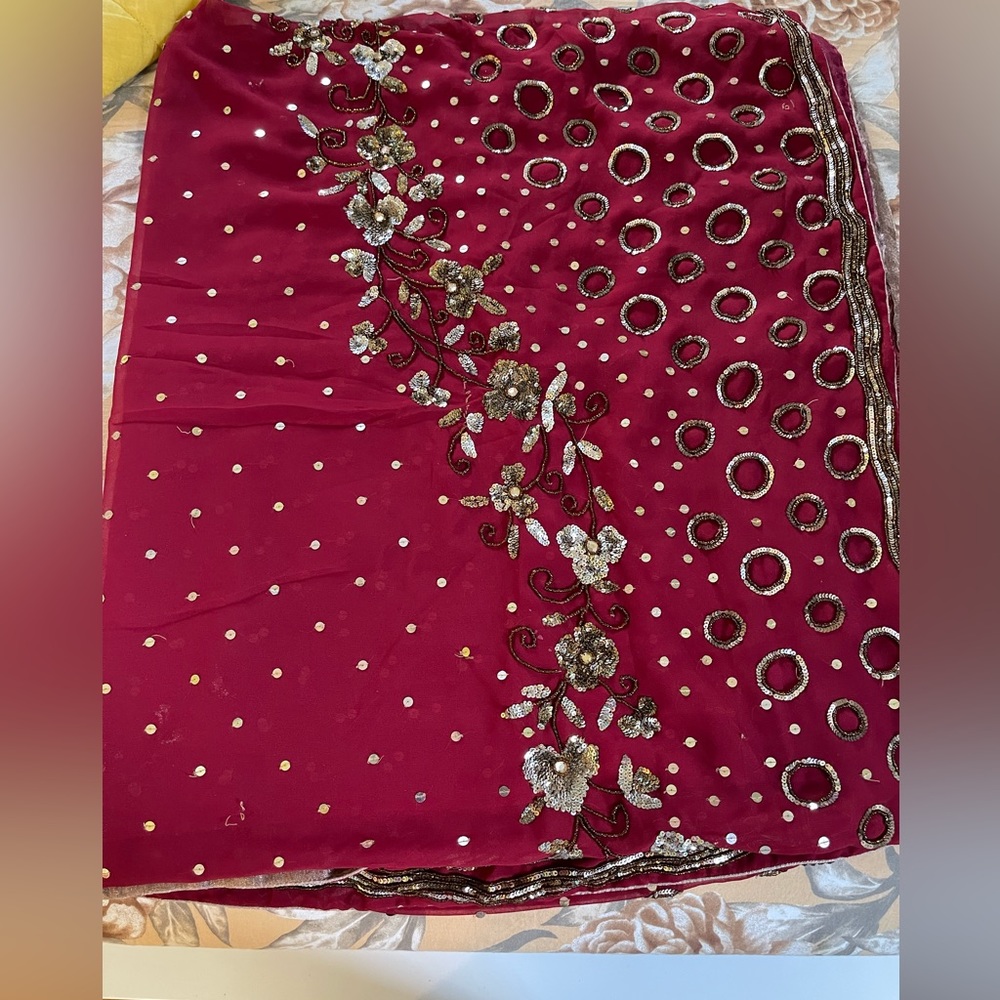 Golden red maroon color saree with stitched blouse. Worn few times.